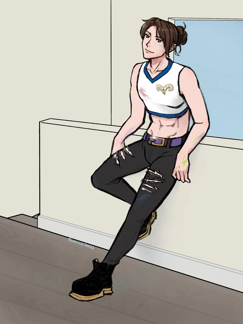 A brown-haired man with a bun leaning against a wall in a white crop top and ripped black jeans.