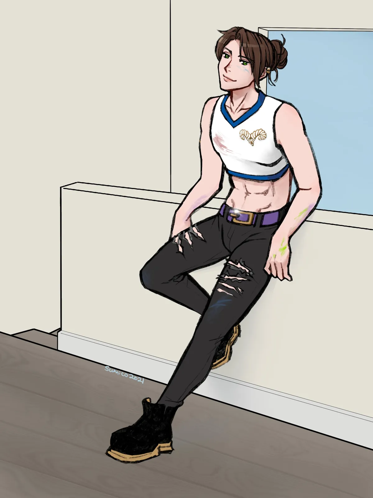A brown-haired man with a bun leaning against a wall in a white crop top and ripped black jeans.